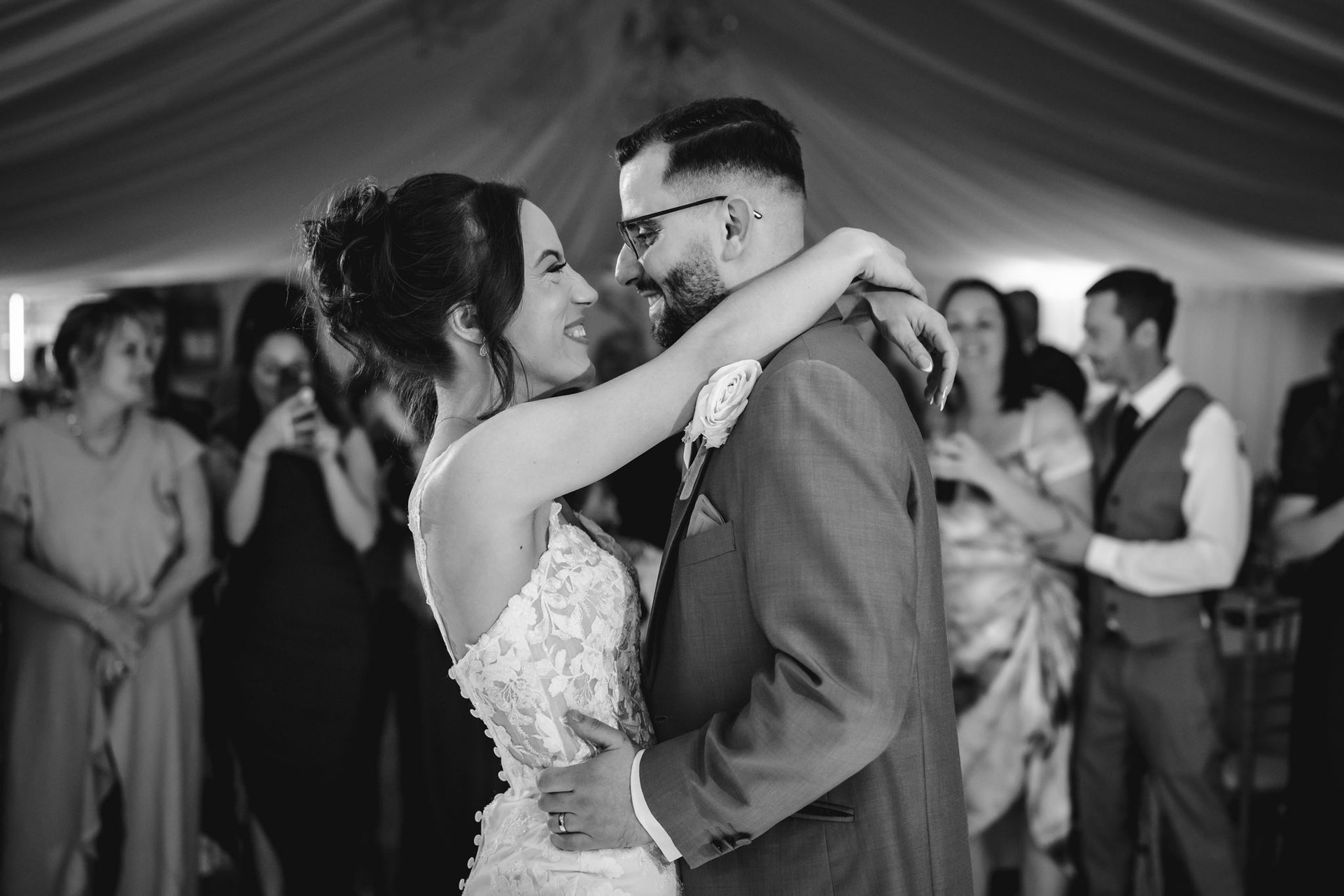 A couple embracing on the dance floor in black and white