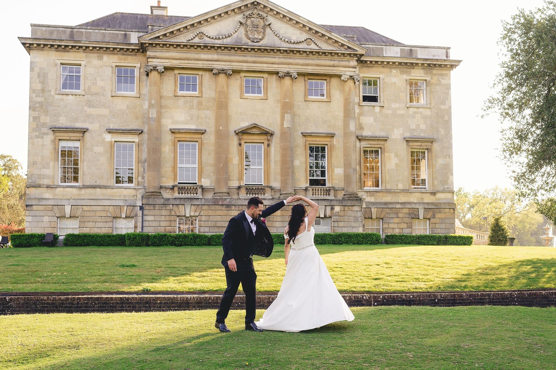 A couple dancing outside a country house