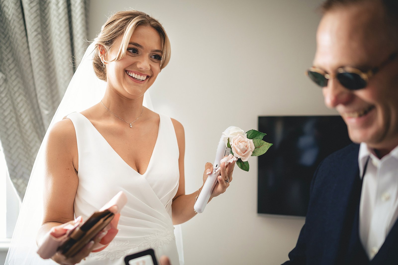 A bride laughing with someone close to her