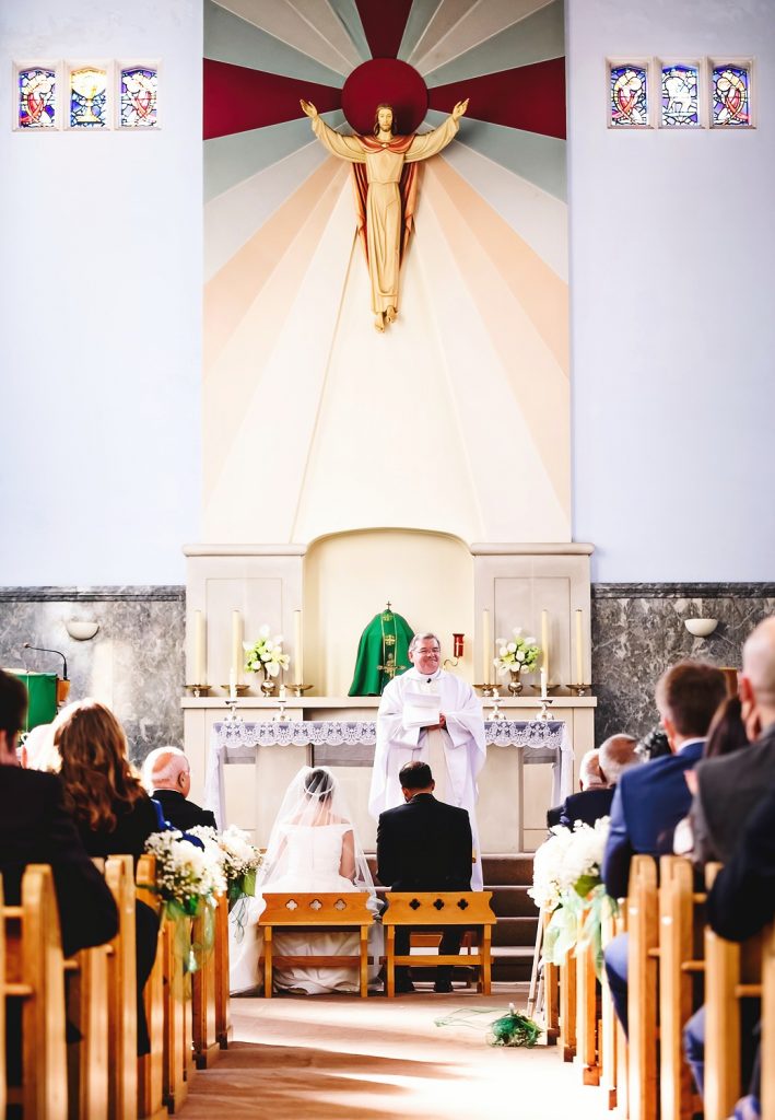 bride and groom sitting in church